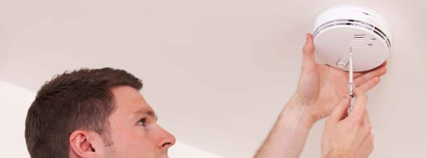 Colin Can Help professional installing a smoke detector to improve home safety for new homeowners in Gates Mills.